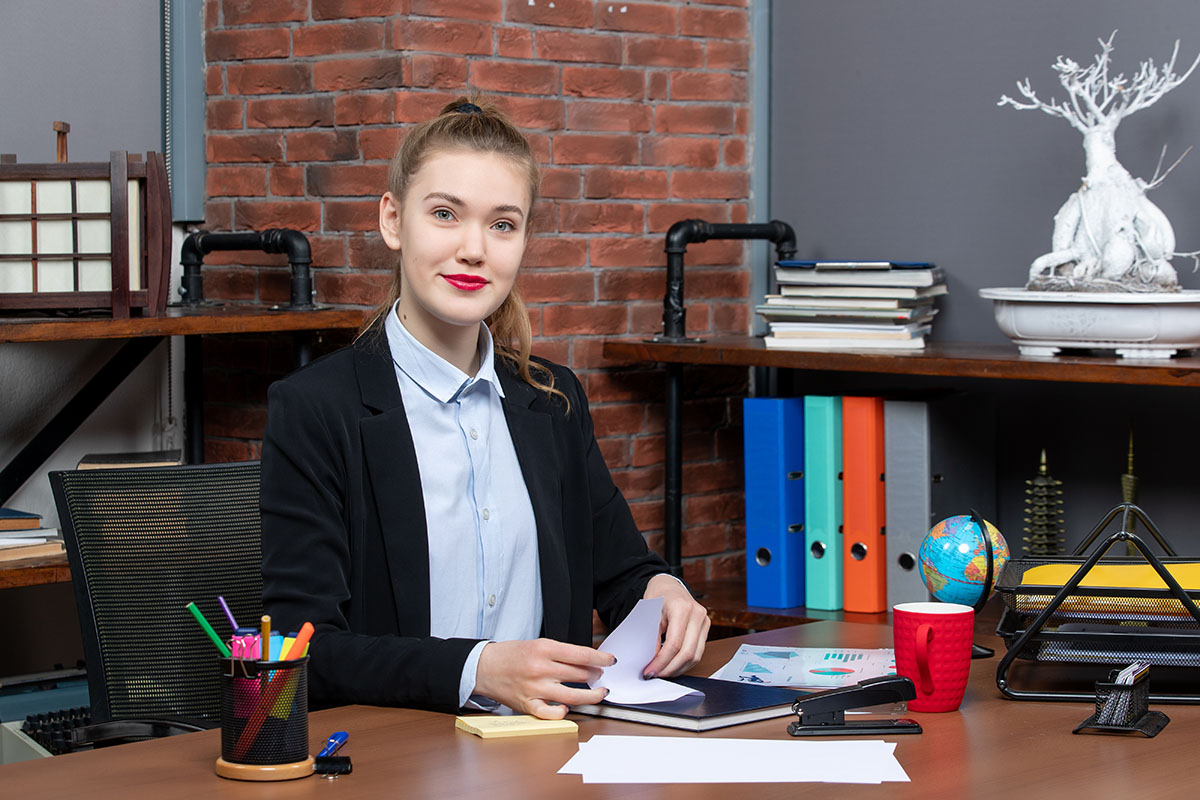 young female office worker sitting at her desk